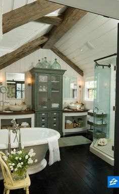 a bathroom with a claw foot tub, sink and shower in the middle of it