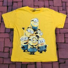 Heavy Cotton Yellow T-Shirt Featuring Minions Size Adult M 100% Heavy Cotton Armpit To Armpit 19" Shoulder To Hem 24" Double Stitched Seams, Bias Covered Seam At Collar Nwot, New, Never Worn Smoke Free Pet Free Environment Yellow Cartoon Print T-shirt For Summer, Yellow Crew Neck T-shirt With Cartoon Print, Yellow Short Sleeve Top With Character Print, Yellow Short Sleeve Shirt With Graphic Print, Casual Yellow Shirt With Cartoon Print, Casual Yellow Short Sleeve T-shirt, Yellow T-shirt With Character Print, Yellow Graphic Tee With Character Print, Fun Yellow Crew Neck Shirt