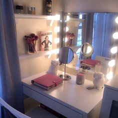 a vanity with lights on it and a mirror