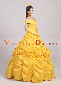 a woman in a yellow dress posing for the camera