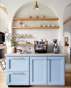 a kitchen with blue cabinets and white walls