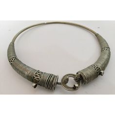 Traditional torque or Hansuli silvered necklace choker from Lambadi or Banjara and Sugali People, Andhra Pradesh, India.t India, circa 1940. Fabulous vintage heavy spiral silvered plated choker necklace in wonderful vintage condition. Silver, but not of the standard of sterling. Spirals of thick silver wire develop in three sections to the left and to the right. On one side of the bridge is a loop, on the other a screw fitting. This sculptural and coiled choker looks truly amazing on any neck or Ceremonial Silver Metal Choker, Antique Silver Metal Choker, Traditional Spiral Silver Jewelry, Traditional Silver Spiral Jewelry, Vintage Silver Beaded Choker, Traditional Spiral Metal Jewelry, Silver Vintage Choker With Intricate Design, Vintage Silver Choker With Intricate Design, Handmade Vintage Spiral Jewelry