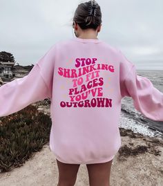 "Stop Shrinking To Fit Places You've Outgrown Sweatshirt, Stop Shrinking To Fit Places Hoodie, Positive Vibes Sweater, Inspirational Sweater Message for any details please!  ☀️☀️☀️☀️☀️ Everything in our shop is hand crafted and made to order. If you want different color or size contact me! If you would like something custom made to fit your personal style please message me and I will do everything to get you that something special. ---How To Order--- ⭐️Please, check and review all photos ⭐️Choose your t-shirt size and color ⭐️Enter your Design Color Example: \"White\" ⭐️Click add to cart. You can go back to add more product ⭐️Click \"Proceed to check out\" ⭐️When you check out, you can add a note to seller for any request *High quality and super soft, comfortable shirt. Made with top of th Oversized Pink Fleece Sweater, Athleisure Long Sleeve Sweater With Letter Print, Pink Letter Print Sweats With Relaxed Fit, Pink Letter Print Relaxed Fit Sweats, Sports Sweatshirt With Text Print And Long Sleeves, Pink Relaxed Fit Sweats With Letter Print, Pink Letter Print Sweats In Relaxed Fit, Pink Fleece Sweatshirt With Letter Print, Pink Crew Neck Sweats With Letter Print