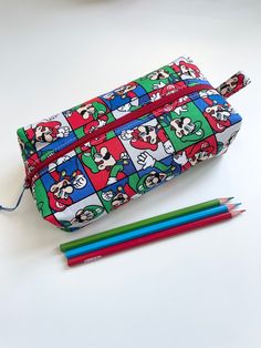 Fun handmade kids boxy zippered pencil case.  Makes a great gift for kids or for the kid at heart to be used as a pencil case or anything else you may need a pouch for!  Made with quality quilting cotton inside and out and interfaced to keep its shape.  Pouch is fully lined and washable. Wash cold water and light dry. Stuff with a towel and apply a Warm iron.  Pencil case approx measurements  8"  long 2.25 inches deep when ironed and stuffed.  3.5 inches bottom width Pencil cases will be mailed Rectangular Pencil Case With Zipper Closure As Gift, Fun Rectangular Pencil Case For Daily Use, Playful Rectangular Pencil Case For Daily Use, Rectangular Educational Pencil Case With Zipper, Rectangular Zipper Pouch Pencil Case As Gift, Novelty Rectangular Pencil Case For Gift, Novelty Rectangular Pencil Case Gift, Fun Multicolor Pencil Case For Gift, Fun Multicolor Pencil Case Gift