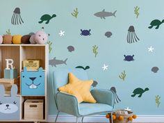 a child's room with blue walls and wall decals on the walls, including an ocean theme