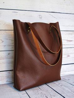 Stylish chocolate leather tote: perfect for use as a shopper or casual tote.  Made with a quality German bull hide. The leather is tough and durable and has been treated with a top-coat which preserves the original texture and marks/scars in the animals skin. Natural suede lining. Sturdy brown leather handles and antique-look rivets.  ***Dimensions***  Width/Height/Depth: 38(top)x36x8cm or 14x13.5x3 inches Straps: approx 65 cm  Please ask if you have any questions. Large Purse, Chocolate Leather, Purse For Women, Hobo Bags, Leather Hobo Bag, Casual Tote, Animal Skin, Leather Handles, Leather Hobo