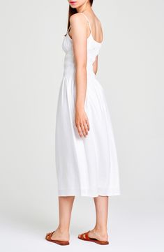 A stretchy smocked bodice shapes the silhouette of a party-ready midi sundress cut from a fresh linen blend perfect for warm weather. Scoop neck Lined 54% linen, 46% viscose Dry clean Imported Midi Sundress With Fitted Bodice For Brunch, Midi Length Sundress With Fitted Bodice For Brunch, Brunch Sundress With Fitted Bodice, Midi Length, Midi Dress With Smocked Back And Fitted Bodice, Fitted Bodice Smocked Back Midi Dress, Fitted Bodice Midi Dress With Smocked Back, Spring Brunch Empire Waist Smocked Dress, Knee-length Sundress With Smocked Bodice For Daywear, Fitted White Dress With Elastic Neckline