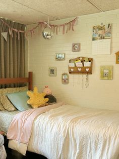 a bed room with a neatly made bed and pictures on the wall