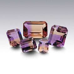 Bi-color ametrine presents an attractive look when rough stones are carefully chosen to produce a stone that's as close as possible to half amethyst and half citrine. Rarely seen with a perfect half-and-half split, the exact proportions from stone to stone vary slightly, giving each stone a unique appearance. This ametrine gemstone coordinates well with either amethyst or citrine, as well as with complementary color stones. ¤ ¤Ametrine is a rare quartz containing both citrine and amethyst; it is Color Stones, Half And Half, Amethyst Quartz, Purple Stones, Latest Jewellery, Rough Gemstone, Tourmaline Gemstone, Gems And Minerals, Jewelry Business