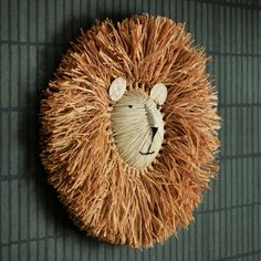 a lion head made out of straw on the wall