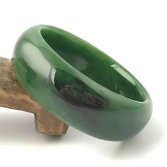 Siberian Jade Bangle. Measures approximately 50mm x 18mm. Elegant Thick Band Bracelet As Gift, Elegant Thick Band Bracelet For Gift, Green Classic Bangle For Formal Occasions, Carved Bangle Bracelet As A Gift, Carved Bangle Bracelet For Gift, Classic Green Bangle Jewelry, Luxury Carved Bracelet Jewelry, Elegant Carved Bracelets As Gifts, Elegant Carved Bracelets For Gifts