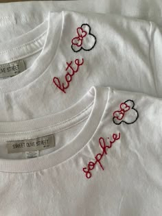 three white tshirts with mickey mouse embroidered on the front and back, sitting next to each other