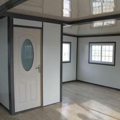 an empty room with white walls and wood flooring is seen in this image from the inside