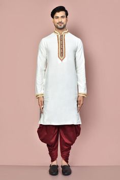 White full sleeve straight kurta with placement hand zardozi embroidery. Paired with a maroon dhoti pant.
Components: 2
Pattern: Placement Embroidery
Type Of Work: Zardozi
Neckline: Stand Collar
Sleeve Type: Full Sleeves
Fabric: Cotton
Color: White
Other Details: 
Embroidered cuffs on kurta
Occasion: Sangeet - Aza Fashions Long Sleeve Festive Kurta For Rituals, Straight Kurta For Eid Rituals, Bollywood Style Kurta For Eid Rituals, Eid Ritual Zari Work Kurta, Eid Rituals Straight Kurta, Bollywood Style Kurta With Zari Work For Rituals, Bollywood Style Kurta For Transitional Rituals, Bollywood Style Straight Kurta For Rituals, Transitional Bollywood Kurta For Rituals