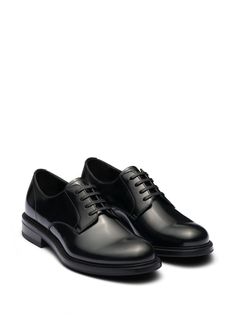 Find PRADA Leather Derby Shoes on Editorialist. black leather brushed finish panelled design logo-debossed tongue branded insole almond toe front lace-up fastening low stacked heel rubber outsole Black Luxury Oxfords With Rubber Heel Cap, Luxury Black Oxfords With Rubber Heel Cap, Black Calf Leather Oxfords With Leather Sole, Classic Black Dress Shoes With Textured Sole, Black Lace-up Shoes With Contrast Sole For Work, Modern Black Lace-up Shoes For Formal Occasions, Black Oxfords With Textured Sole For Derby, Classic Leather Almond Toe Sneakers, Black Oxfords With Textured Sole For Formal Occasions