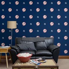 a living room filled with furniture and a wallpaper covered in baseballs on it