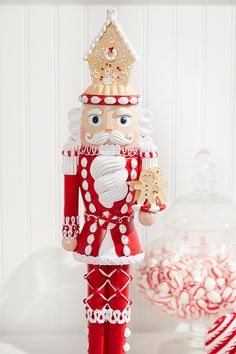 a red and white nutcracker with a gold crown