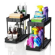 two black trays with cleaning products and bottles on them, one is holding a soap dispenser