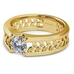 a yellow gold ring with a diamond in the center and an intricate band around it