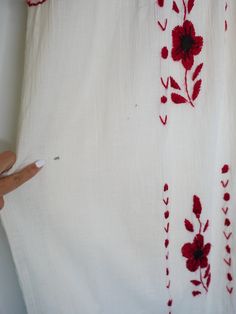 "Beautiful Antique 0ff-White Cotton Gauze Maxi Dress with Floral Hand Embroidery . Features hand embroidered flowers on chest front, neck and sleeves. Half Sleeve drawstring at cuff sleeves. Condition: Good Vintage Condition. ** black spot on hip area and missing embroidered detail on skirt. \"shown in the detailing picture \" BEST FIT = M Please be sure to check the measurements to insure a perfect fit. Details and Measurements (Inch) BUST: 38 \" HIPS: 50 \" FULL LENGTH: 52 \" SLEEVE LENGTH: 11 Traditional White Sleeveless Embroidered Dress, Red Sleeveless Dress With Intricate Embroidery, Red Sleeveless Dress With Floral Embroidery, White Sleeveless Dress With Intricate Embroidery, Red Chikankari Embroidery Summer Dress, White Folk Style Fabric With Floral Embroidery, White Folk-style Fabric With Floral Embroidery, White Folk Dress With Resham Embroidery, White Sleeveless Dress With Chikankari Embroidery