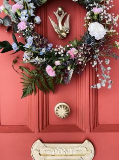 a red door with a wreath on it