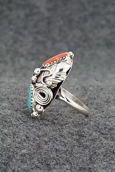 This turquoise, coral and sterling silver ring was made by Navajo silversmith Max Calladitto. The inside of the band is signed and stamped sterling.Size: 5.5Length: 1 1/8"Width: 5/8"Free shipping on all orders! We ship with USPS and always include tracking. All orders ship within a day of payment.Returns are accepted up to 30 days after you receive your order. Just send us a message. Our shop offers cash back or store credit. The item must be returned in new condition. Anniversary Sterling Silver Multi-stone Turquoise Ring, Anniversary Turquoise Multi-stone Ring In Sterling Silver, Anniversary Turquoise Multi-stone Sterling Silver Ring, Anniversary Multi-stone Turquoise Ring In Sterling Silver, Southwestern Multi-stone Rings For Anniversary, Unique Multi-stone Turquoise Ring In Sterling Silver, Coral Turquoise, The Band, Sterling Silver Ring