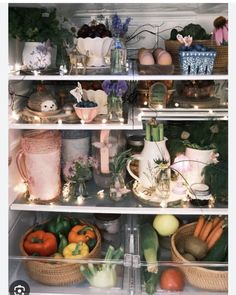 an open refrigerator filled with lots of different types of vegetables and fruit in baskets on the shelves