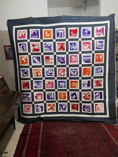 a large quilt is on display in a room