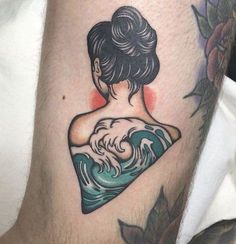 a woman's arm with a tattoo on it and an ocean wave behind her