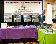 there is a table with many items on it at the convention or wedding fair that has been set up