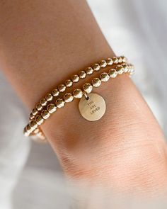 This 1/2" hammered coin bracelet is a beautiful vessel to carry your special mantra. The hammered coin charm reminds you of the beauty of your authentic self, while the back of the charm offers ample space for a meaningful message for your personal journey. Crafted from high-quality 14k gold-filled or .925 sterling silver beads, this stretch bracelet strikes the perfect balance between minimalism, elegance, and practicality. It seamlessly transitions from the office to weekend outings, adding a Empathy Cards, Word Bracelet, Coin Bracelet, Meaningful Messages, You Are Loved, Personal Journey, Authentic Self, Layered Bracelets, Love Bracelets