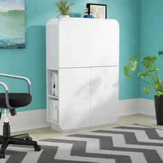 an office chair sits in front of a white cabinet