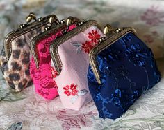 Dimension:  Length(5.5in) x Width(2.5in) x Height(5in) These are beautiful stylized coin purses which is unique and currently in fashion. The come in deep blue, peach with a floral design, hot pink with pink floral lace, and simulated leopard spots. The coin purses have a kiss lock closure. They have antique gold color closure. The coin purses are stylish, elegant, and inexpensive. They are both popular and functional. They have plenty of room to store personal items and spare change. The purses open and close at the top middle where a round sphere kiss lock closure is seated. Kiss Lock Purse, Cute Coin Purse, Lace Bag, Wedding Handbag, Random Items, Painted Bags, Spare Change, Card Purse, Floral Purse