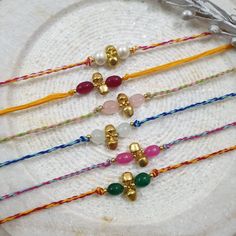 Stone Ghungroo Rakhi For Brother, Protection and Prosperity Bracelet, Pearl Rakhi For Kids, Rakhi Hamper for Brother, Rakhi Card (pack of 1) Length: Freesize Material: 100% cotton thread (soft thread) Package: Pack of 1 Design: Choose a stone color from the drop-down menu Rakhi, also known as Raksha Bandhan, is a traditional Indian festival that celebrates the special bond between brothers and sisters. It is a joyous occasion where sisters tie a decorative thread called a rakhi around their brot Handmade Friendship Bracelets For Festivals As Gift, Gold Friendship Bracelets For Festivals, Gold Jewelry For Friendship Festivals, Multicolor Spiritual Bracelets For Puja, Spiritual Multicolor Bracelets For Puja, Spiritual Beaded Bracelets For Friendship And Festivals, Traditional Gold Bracelet With Sliding Knot, Spiritual Friendship Bracelets As Festival Gifts, Adjustable Spiritual Friendship Bracelets For Festivals