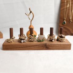 an assortment of rings on a wooden stand