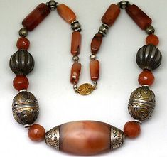 Necklace is 23" long. Total weight: 165 grams. Large Tibetan Agate bead and most other carnelian beads are more than 700 years old. Elegant Chalcedony Jewelry With Polished Beads, Elegant Carnelian Beaded Necklace With Round Beads, Elegant Carnelian Beaded Necklace With Gemstone Beads, Polished Round Carnelian Beads Jewelry, Elegant Polished Carnelian Beads, Antique Amber Jewelry With Large Beads, Antique Amber Jewelry With Polished Beads, Antique Oval Carnelian Jewelry, Elegant Orange Carnelian Beaded Necklace