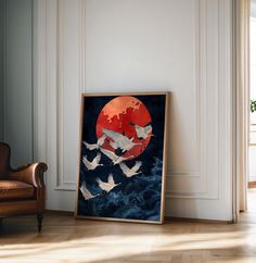 there is a painting on the wall with birds flying in front of it and a chair next to it