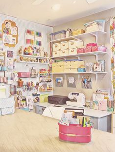 a sewing room with lots of craft supplies