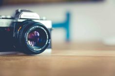 a camera sitting on top of a wooden table