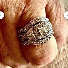 a man's hand with two rings on it and the other one has an engagement ring