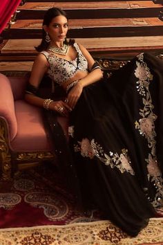 Black attached cancan skirt with bead, thread, cutdana embroidery in floral placement pattern. Paired with sleeveless embroidered padded blouse and dupatta. - Aza Fashions Sleeveless Lehenga With Intricate Embroidery For Party, Party Lehenga With Intricate Embroidery And Sleeveless Design, Sleeveless Party Lehenga With Intricate Embroidery, Embellished Wedding Sets, Elegant Sleeveless Embellished Lehenga, Embellished Sleeveless Choli For Evening, Hand Embellished Sleeveless Party Choli, Bollywood Style Sleeveless Lehenga For Evening, Bollywood Style Sleeveless Evening Lehenga