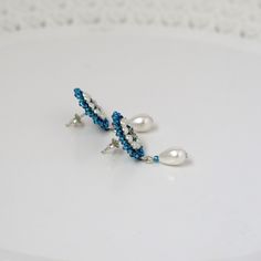 "I created this blue stud earring by hand, using Swarovski 3mm pearls, Miyuki round seed beads, and sterling silver post-with-friction-back Vintage style, feminine and impressive * Measurements: Earrings diameter: 0.59\" (1.5cm) Earrings Length (with drop): 1.33\" (3.4cm) * The earrings will come beautifully packaged for a gift. *Additional information on the matching necklace you can see here: https://www.etsy.com/il-en/listing/231323832/blue-statement-necklace-blue-wedding?ref=related-1 * For Handmade Blue Pearl Earrings In Sterling Silver, Handmade Blue Sterling Silver Pearl Earrings, Blue Beaded Drop Earrings For Wedding, Handmade Blue Pearl Drop Earrings, Blue Round Bead Earrings For Wedding, Blue Sterling Silver Pearl Earrings As Gift, Handmade Blue Drop Bridal Earrings, Blue Pearl Drop Bridal Earrings As Gift, Handmade Blue Bridal Drop Earrings