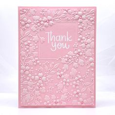 a pink thank you card with flowers on it