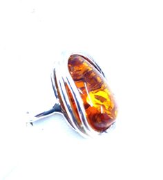 So shiny and sparkling! Silver layered setting for an extra touch! Stones: Cognac Baltic Amber SKU: AMRG020624-05 Dimensions: 1" long x 3/4 "wide x 1/2" depth Sizes adjustable 7.5 to 9 Material: .925 Sterling Silver Made In: Poland Adjustable Cabochon Ring For Formal Occasions, Adjustable Cabochon Rings For Formal Occasions, Formal Adjustable Rings With Polished Finish, Adjustable Oval Amber Ring, Adjustable Amber Jewelry For Formal Occasions, Statement Pendant, Jewelry Repair, Pendant Rings, Baltic Amber