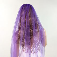 a woman with purple hair wearing a veil