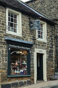 an old brick building with a store front