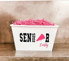 a white container filled with pink sprinkles on top of a counter