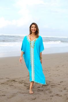 Add a tribal twist to your beach time in this black and gold summer maxi swimwear cover up. Zigzag embroidery adds a spicy accent to this long beach caftan, with a casual vacation vibe and a loose flowy fit that works beautifully on plus sizes. It offers great sun coverage, and is so easy to wear for cruises, lounging, vacation or relaxing days at the beach. Back From Bali is dedicated to creating beautiful, quality clothing with a heart. All of our items are crafted, sewn and painted by hand in Grey Swimsuit, Beach Poncho, Beach Caftan, Duster Dress, Beach Tunic, Shrug For Dresses, Loungewear Dresses, White Swimsuit, Summer Maxi