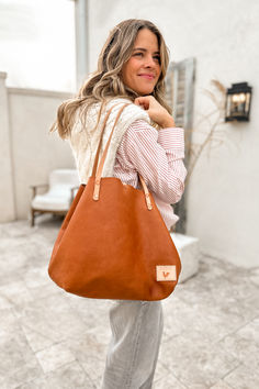 The Perfect Tote is designed for a lifetime of busy days and getaways. A spacious and chic bag that features a large open top, comfy shoulder handles, and an exterior pocket for easy phone access. With a 2-way clasp closure and a small interior zip pocket, it keeps your belongings secure and organized. Crafted with two exquisite full grain, vegetable-tanned leathers (Bark or Saddle), this bag is built to last a lifetime. Lynchburg Virginia, Waxed Canvas Bag, Raw Leather, Fanny Bag, Tan Cowhide, Saddle Leather, Chic Bags, Leather Conditioner, Navy Floral