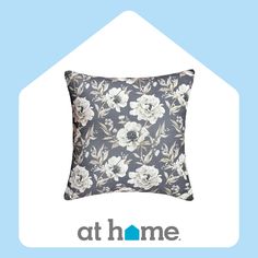 a blue and white flowered pillow with the words athome on it's side